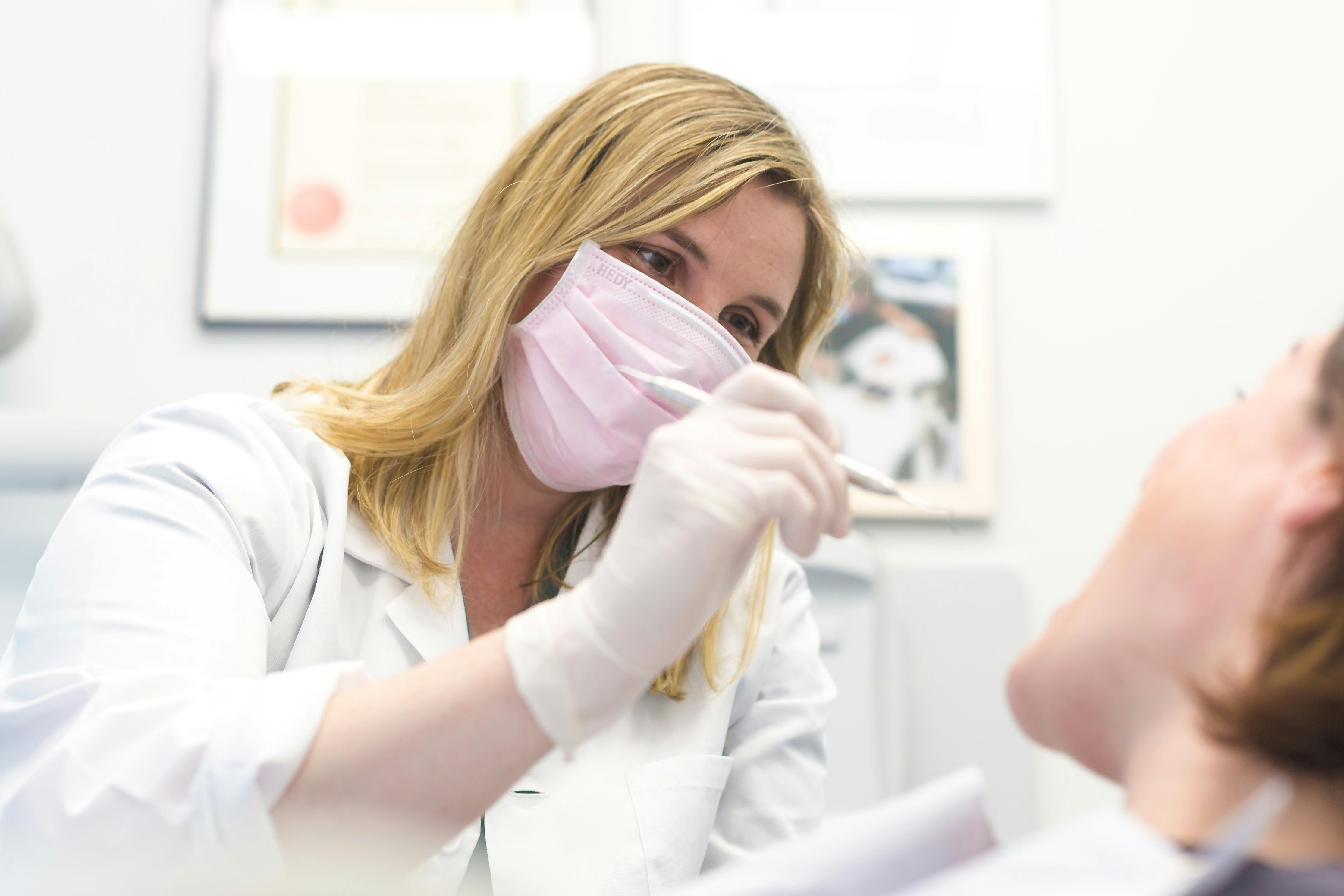 Dental practice manager reviewing sponsorship documentation and GDC registration requirements for overseas dentist